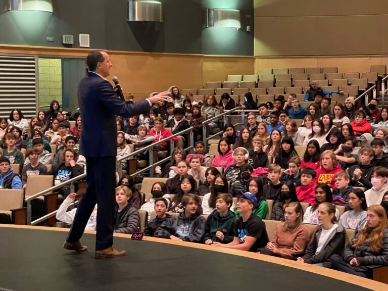 Mike Domitrz speaking to students during a consent and respect school assembly at a high school auditorium
